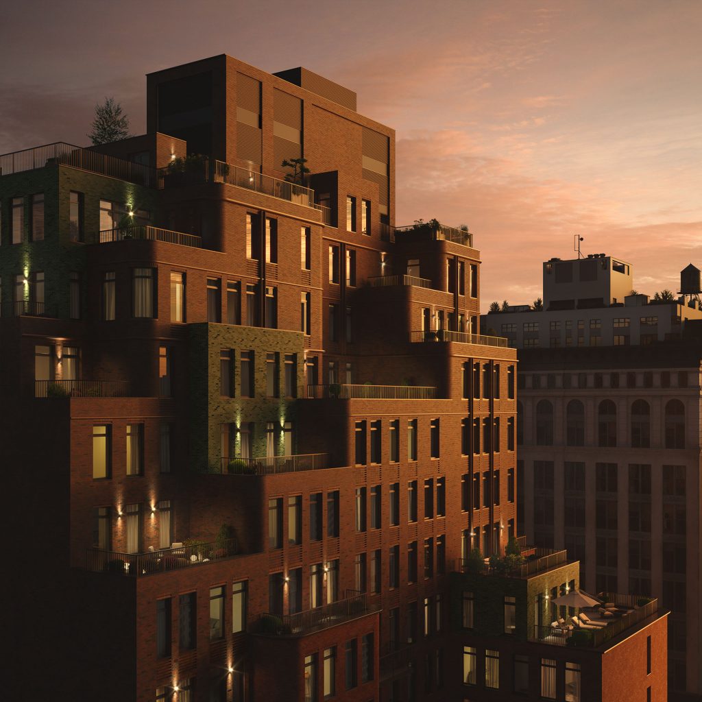 Birdseye view of The Village West condominiums at night showing the private terraces and city views.